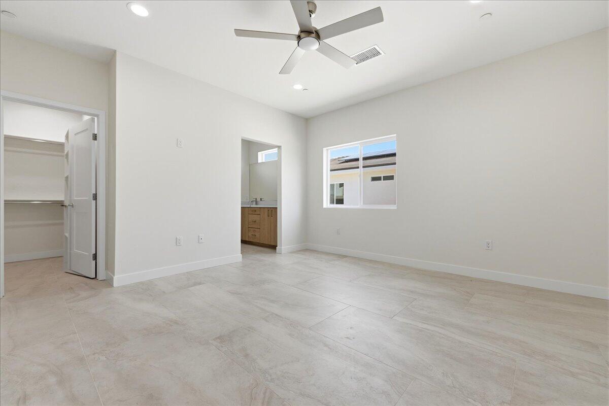 68160 Modalo Road Cathedral City, CA 92234 - Photo 17 of 57 an empty room with windows and ceiling fan