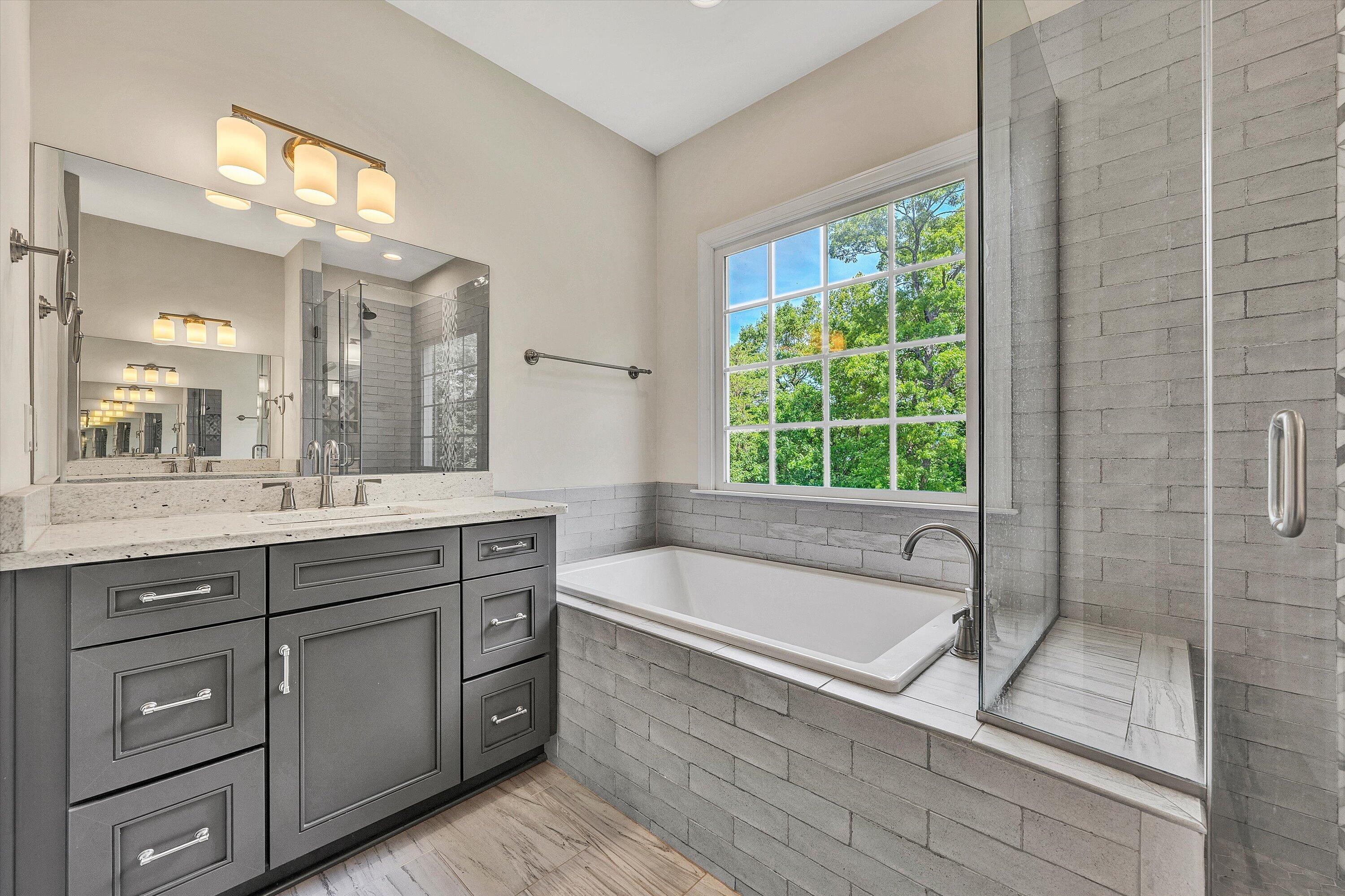6981 Fairway Ridge Road Salem, VA 24153 - Photo 28 of 53 a spacious bathroom with a granite countertop tub a sink and a large mirror