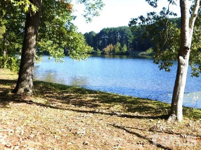 a view of a yard with wooden fence