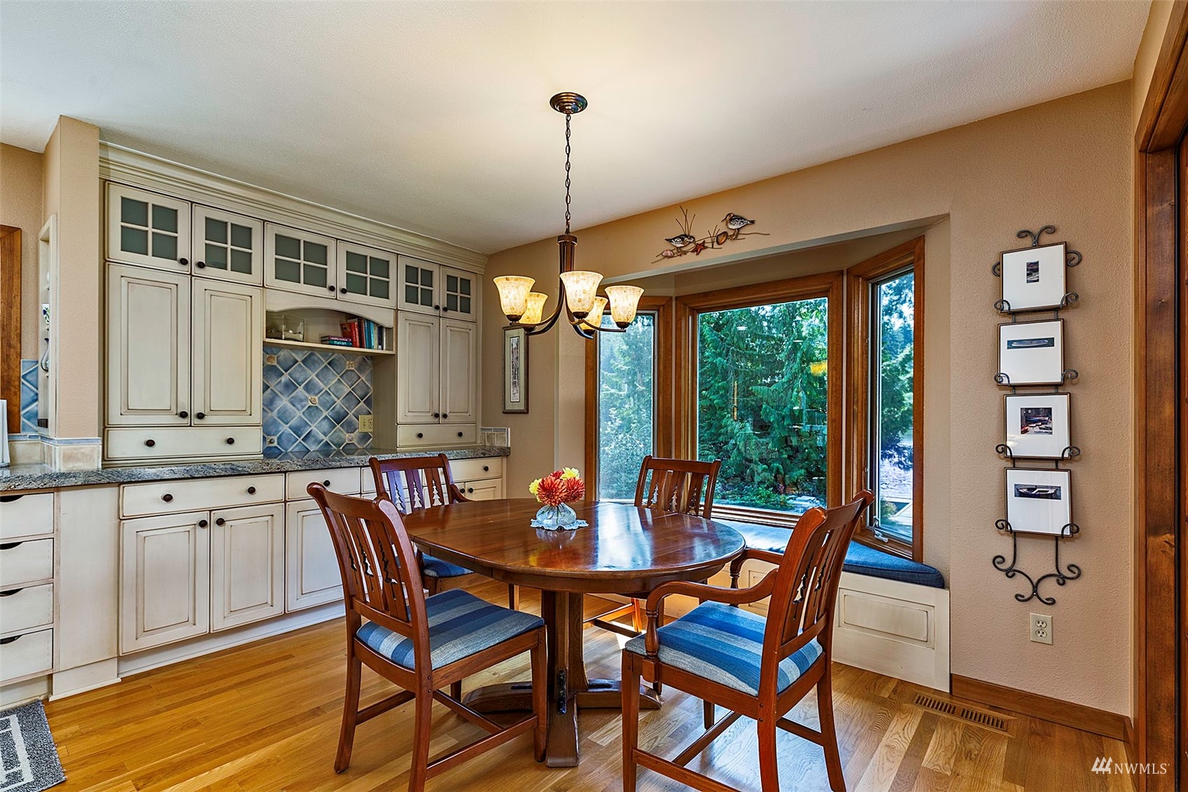 10518 Guthrie Road Anderson Island, WA 98303 - Photo 12 of 40 a view of a dining room with furniture window and wooden floor