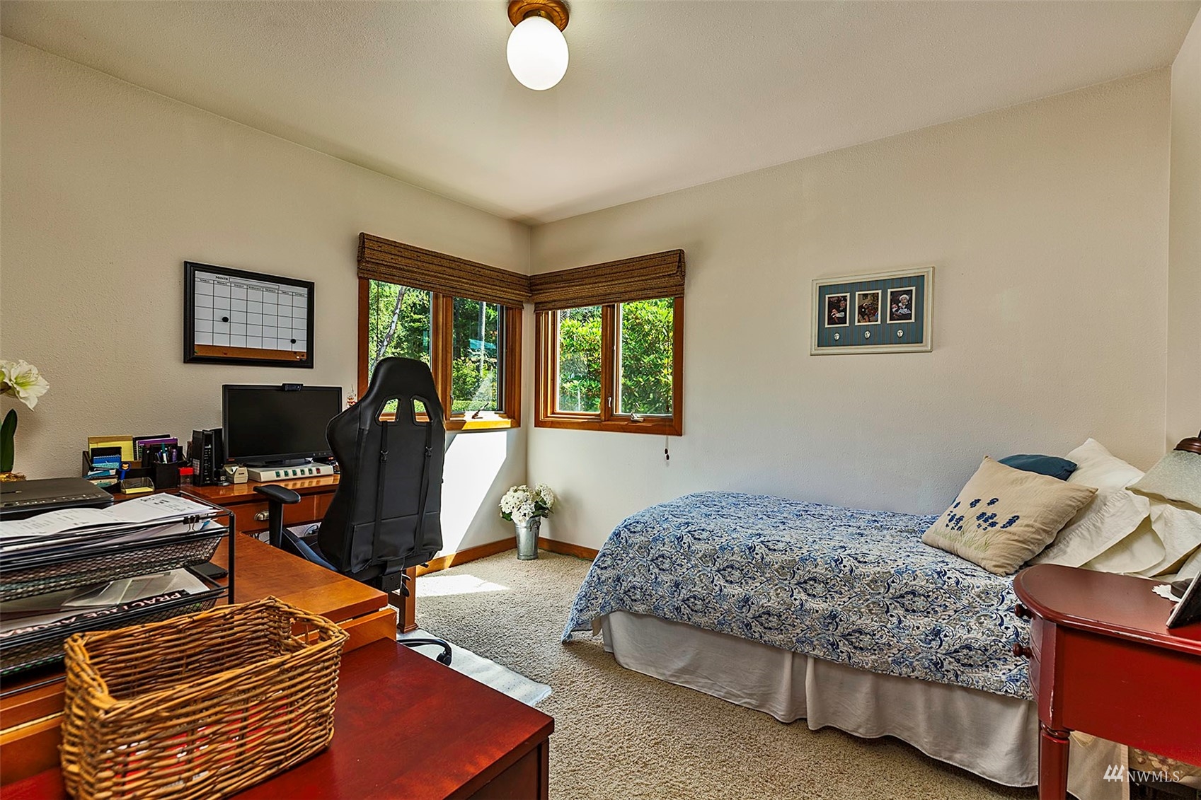 10518 Guthrie Road Anderson Island, WA 98303 - Photo 19 of 40 a bedroom with a bed and wooden floor