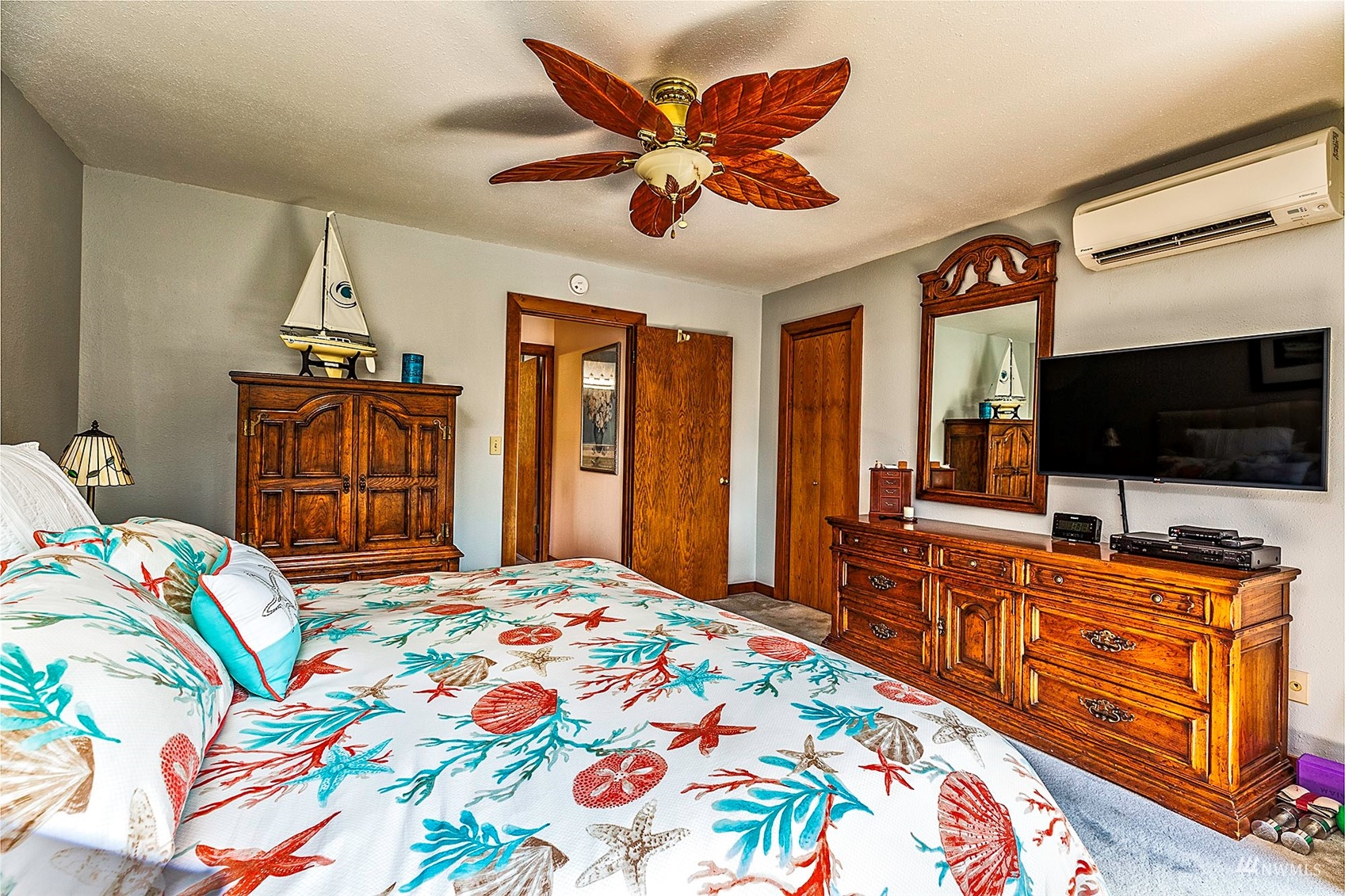 10518 Guthrie Road Anderson Island, WA 98303 - Photo 22 of 40 a bedroom with a bed and a flat screen tv