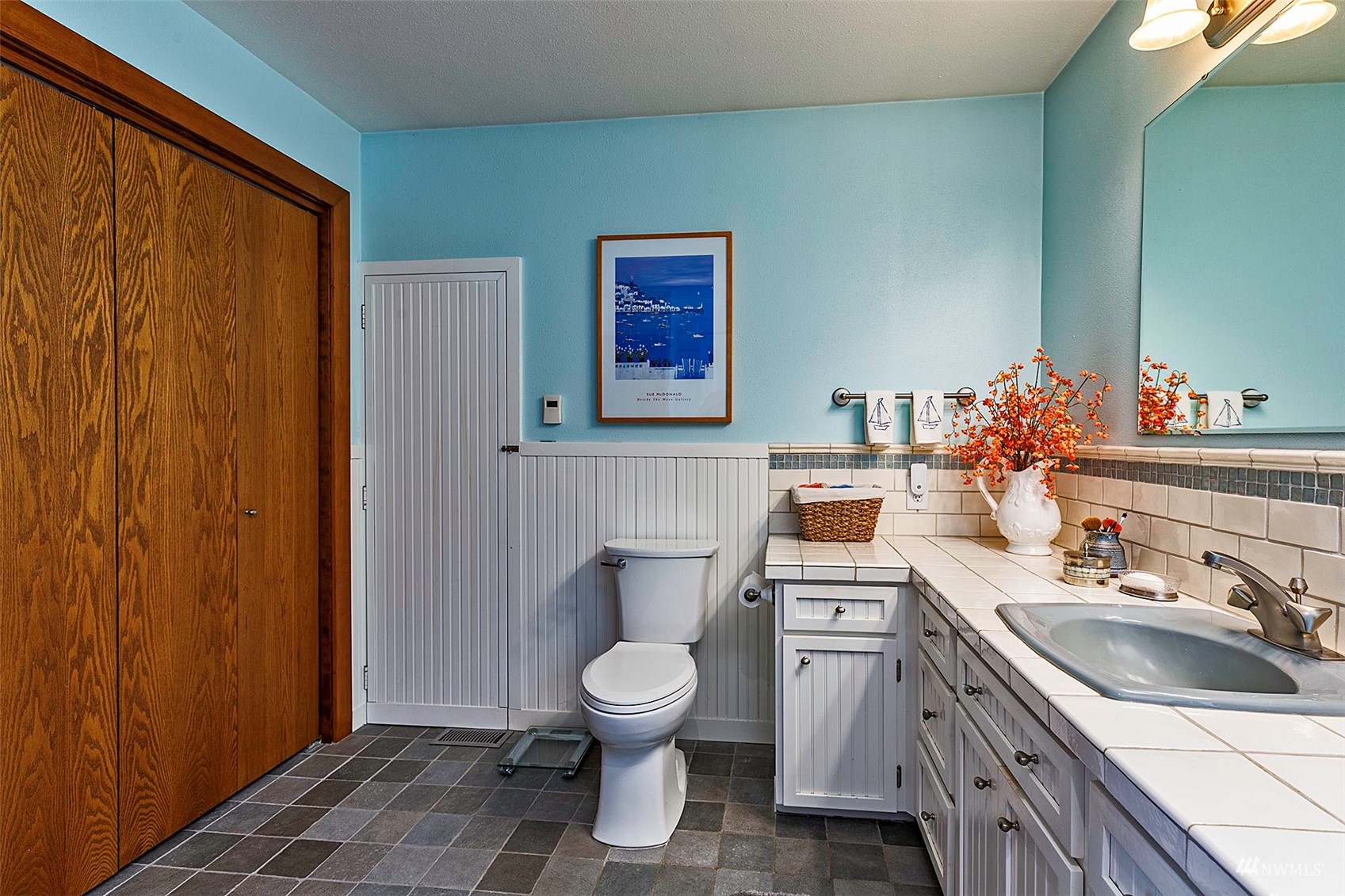 10518 Guthrie Road Anderson Island, WA 98303 - Photo 25 of 40 a bathroom with a sink a toilet and mirror