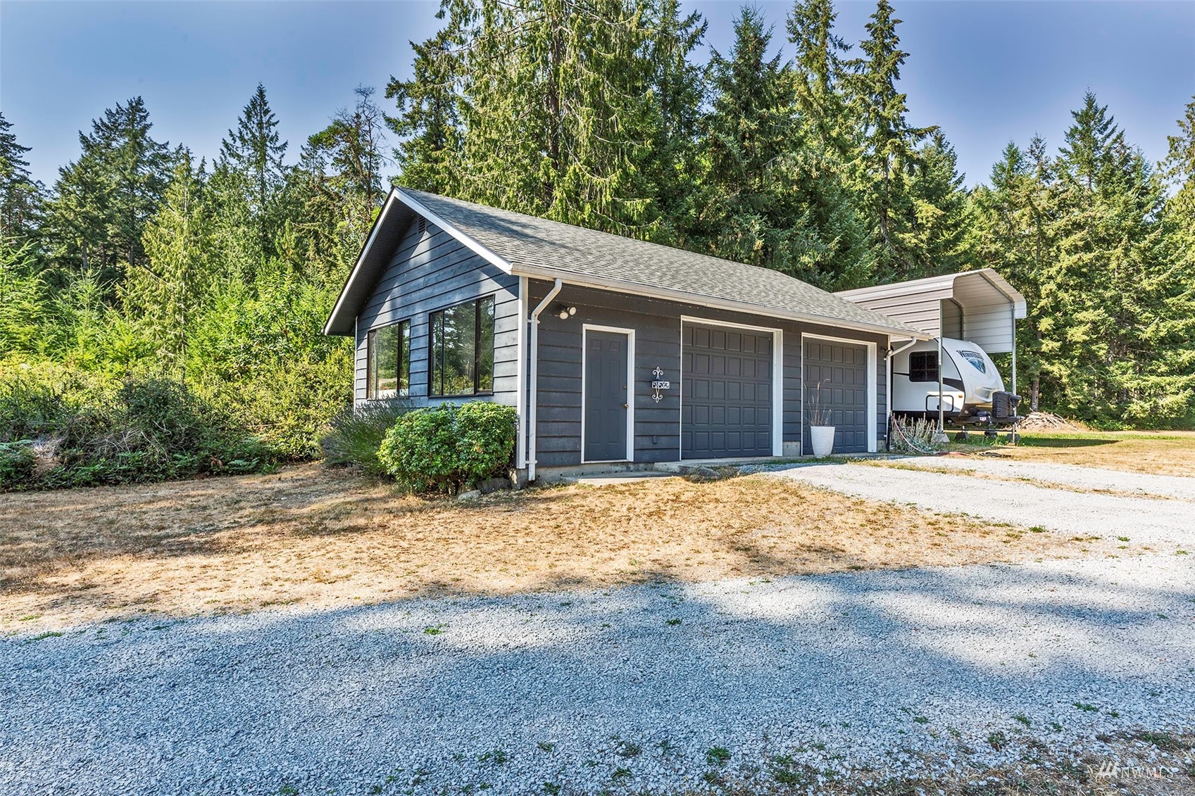 10518 Guthrie Road Anderson Island, WA 98303 - Photo 36 of 40 a view of a house with a yard and large tree