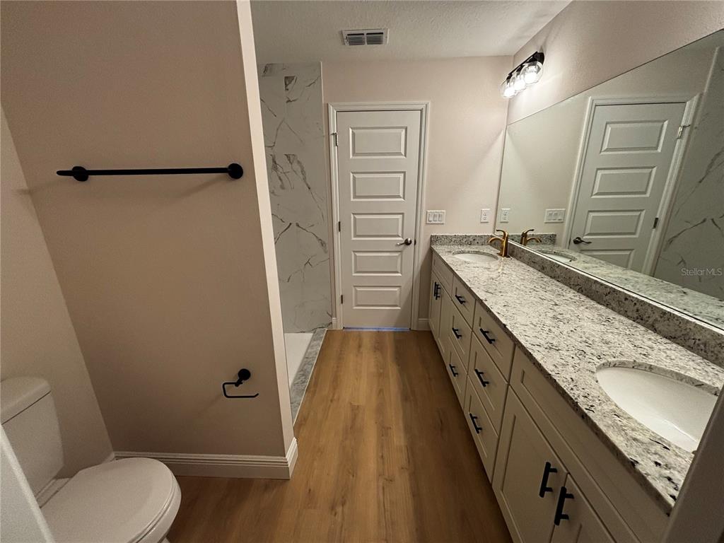 3148 Southwest 145th Court Ocala, FL 34481 - Photo 11 of 17 a bathroom with a granite countertop sink toilet and shower