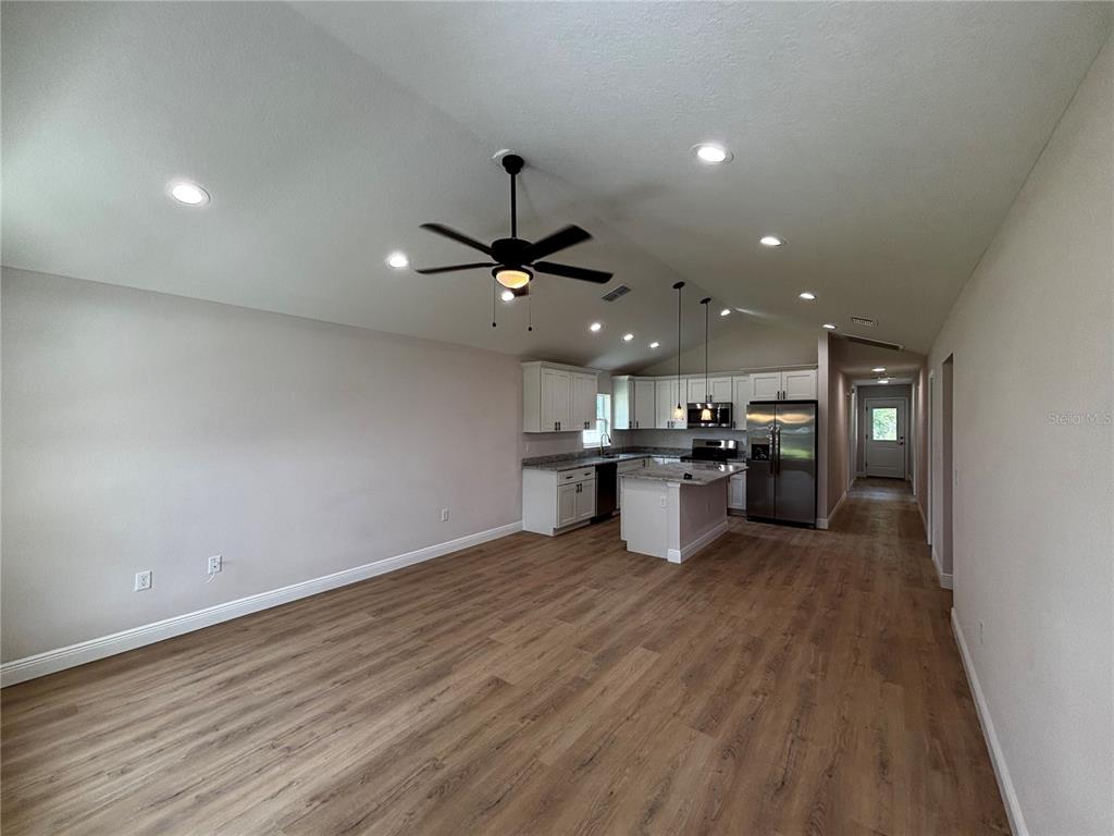 3148 Southwest 145th Court Ocala, FL 34481 - Photo 3 of 17 a view of kitchen with kitchen island microwave and stove
