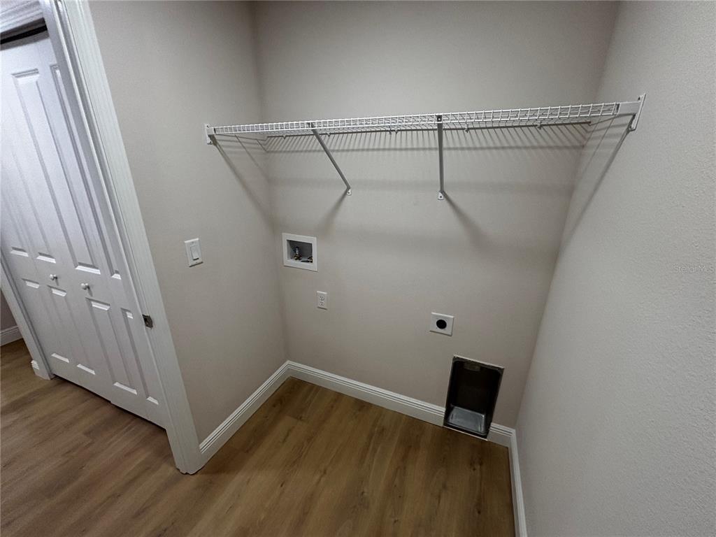 3148 Southwest 145th Court Ocala, FL 34481 - Photo 7 of 17 a view of a room with wooden floor and white walls