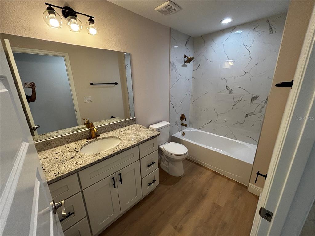 3148 Southwest 145th Court Ocala, FL 34481 - Photo 9 of 17 a bathroom with a granite countertop sink toilet and shower