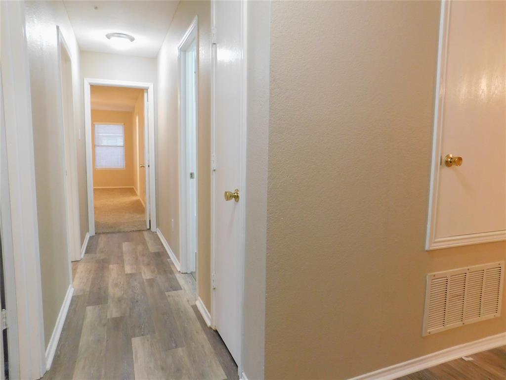 8105 Winding Stream Lane Denton, TX 76210 - Photo 12 of 28 a view of a hallway with wooden floor