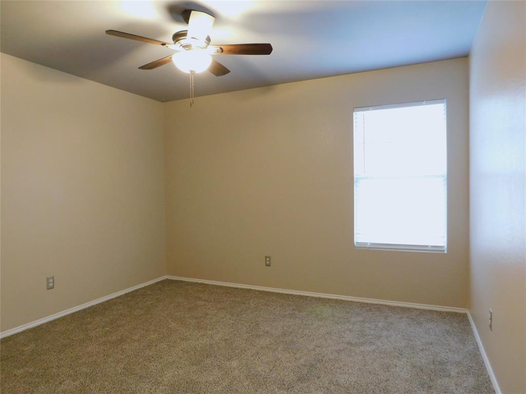 8105 Winding Stream Lane Denton, TX 76210 - Photo 14 of 28 an empty room with a window and a fan