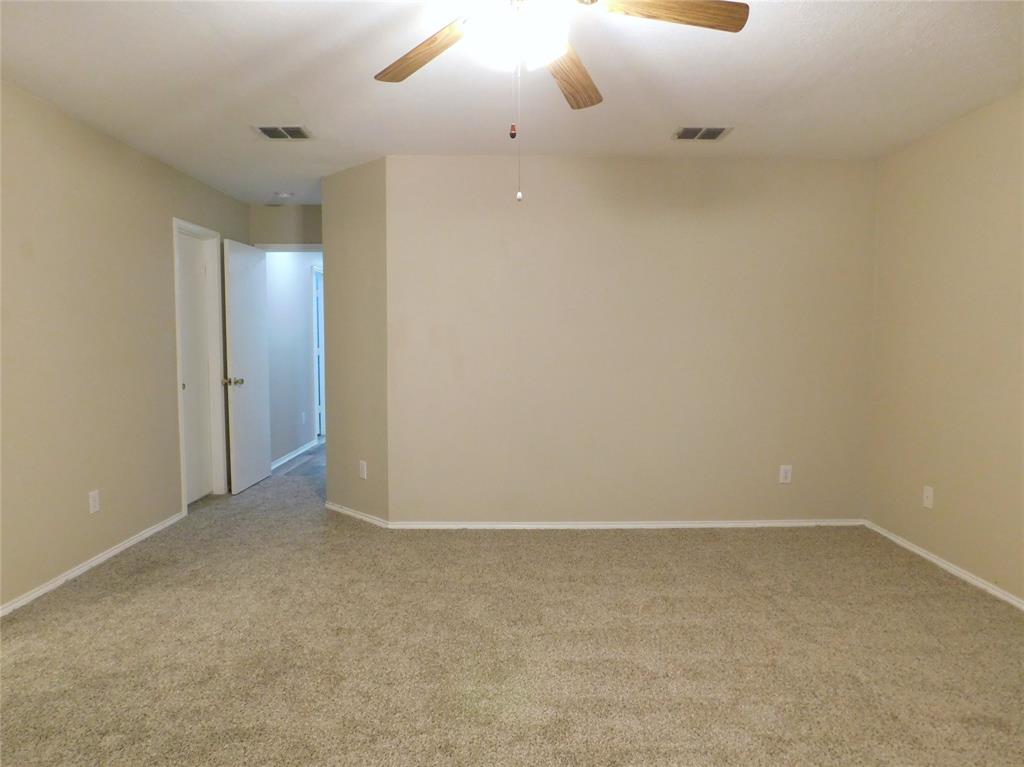 8105 Winding Stream Lane Denton, TX 76210 - Photo 18 of 28 an empty room with a empty space and a ceiling fan