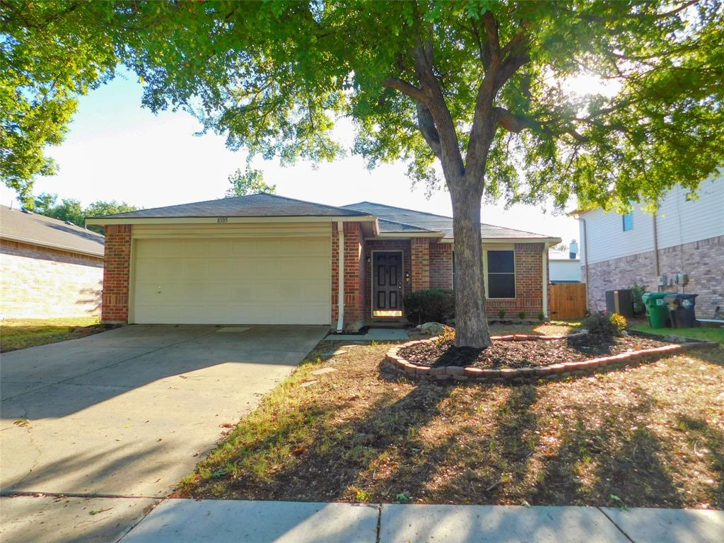 8105 Winding Stream Lane Denton, TX 76210 - Photo 2 of 28 a front view of a house with garden