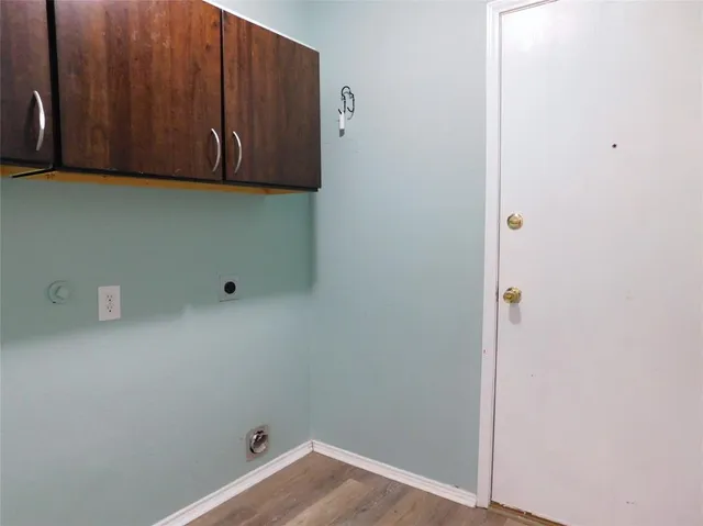 a view of storage and utility room with wooden floor