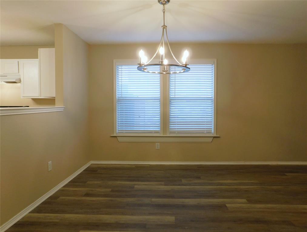 8105 Winding Stream Lane Denton, TX 76210 - Photo 7 of 28 a view of empty room with wooden floor and chandelier