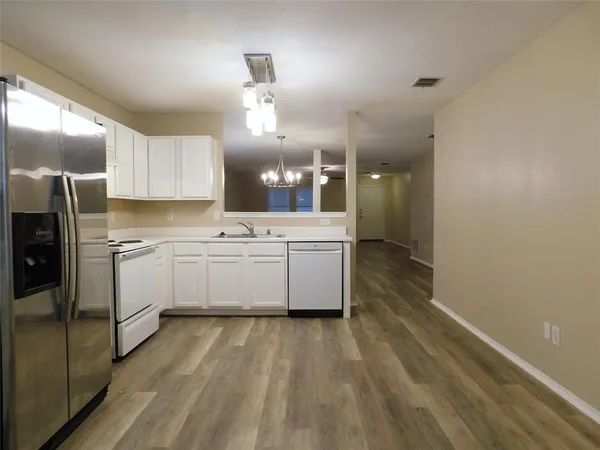a kitchen with cabinets a sink and appliances