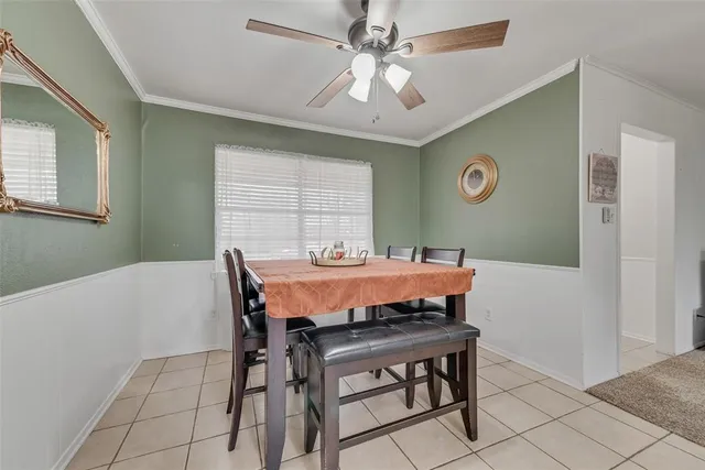 a view of a dining room with furniture and a chandelier fan