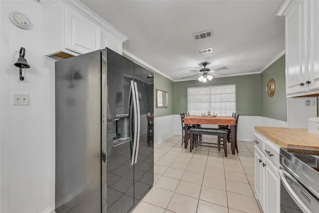 a kitchen with stainless steel appliances granite countertop a refrigerator and a stove
