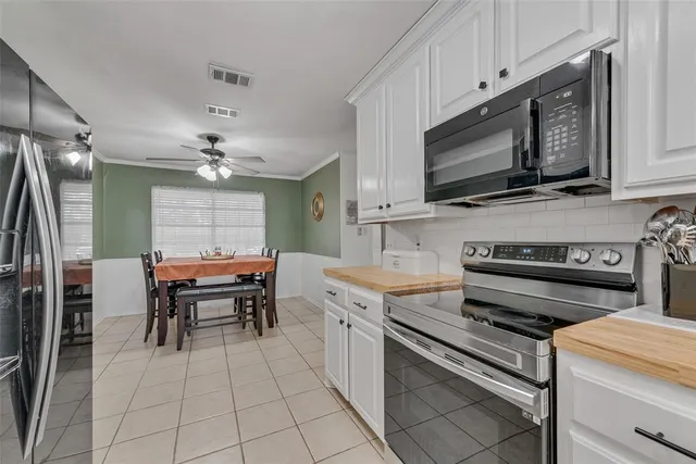 a kitchen with appliances cabinets and furniture