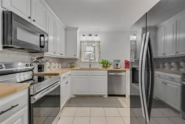 a kitchen with a refrigerator sink and microwave