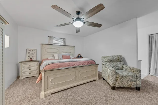 a bedroom with bed and window