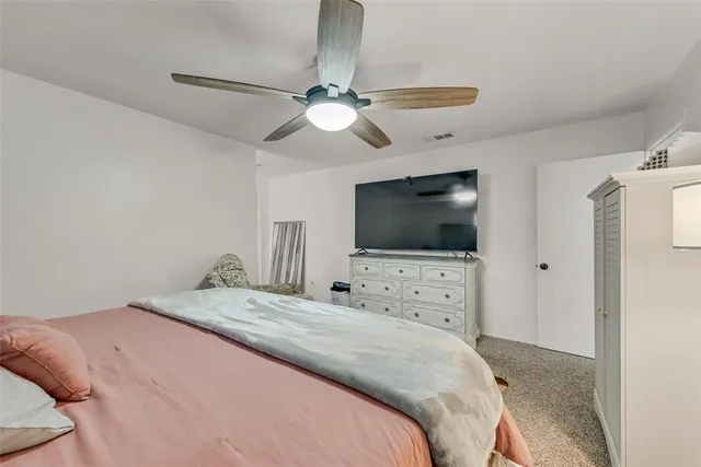 a bedroom with a flat screen tv and a bed