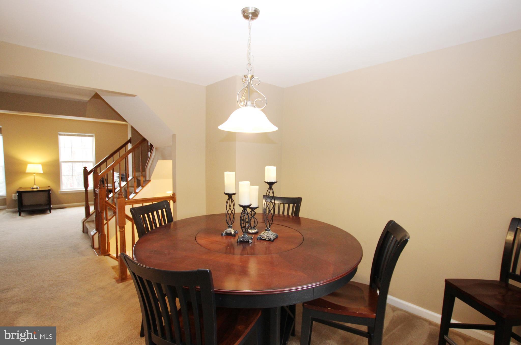1315 Steed Street Ranson, WV 25438 - Photo 14 of 30 a dining room with furniture and a chandelier