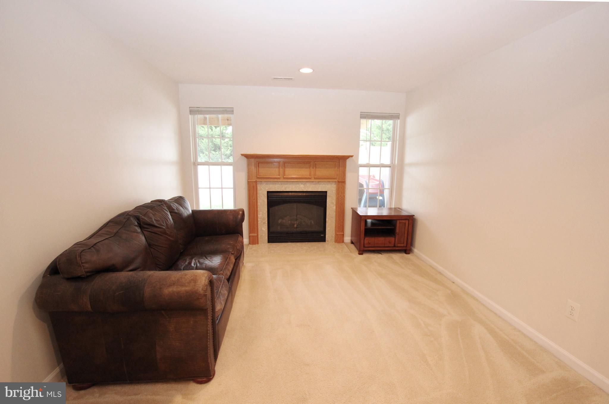 1315 Steed Street Ranson, WV 25438 - Photo 7 of 30 a living room with furniture and a fireplace