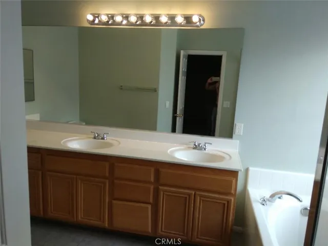 a bathroom with a double vanity sink and mirror