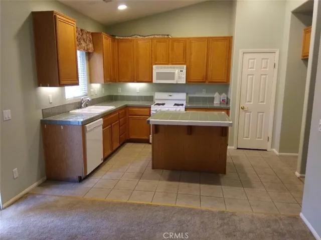 a kitchen with stainless steel appliances granite countertop a stove and a refrigerator
