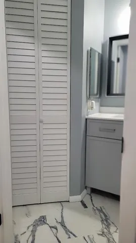 a view of a bathroom with a sink and a mirror