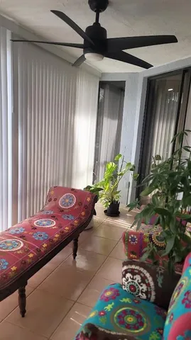 a bedroom with a bed and a potted plant