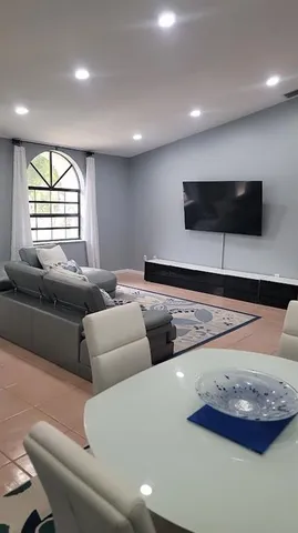 a living room with furniture and a flat screen tv