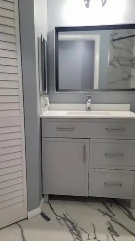a bathroom with a sink and a mirror