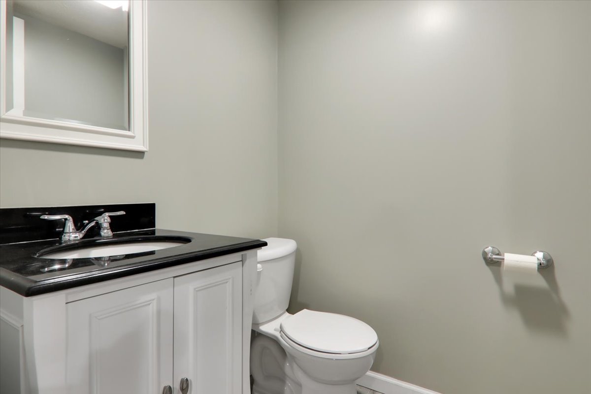 1204 Colonial Avenue Bloomington, IL 61701 - Photo 15 of 17 a bathroom with a granite countertop toilet and sink