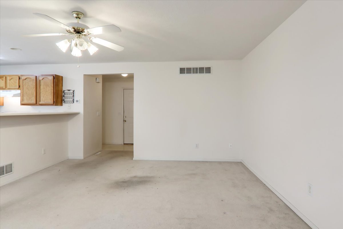 1204 Colonial Avenue Bloomington, IL 61701 - Photo 3 of 17 an empty room with a chandelier fan and windows