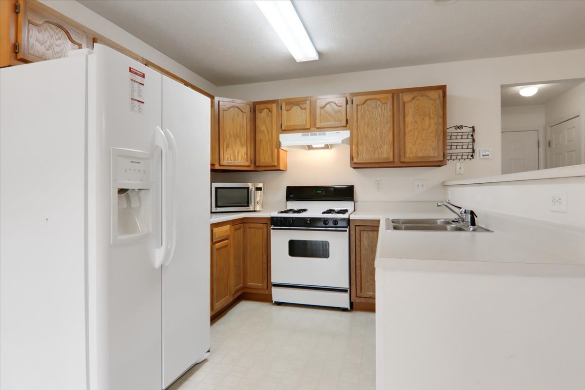 1204 Colonial Avenue Bloomington, IL 61701 - Photo 5 of 17 a kitchen with stainless steel appliances a refrigerator sink and stove