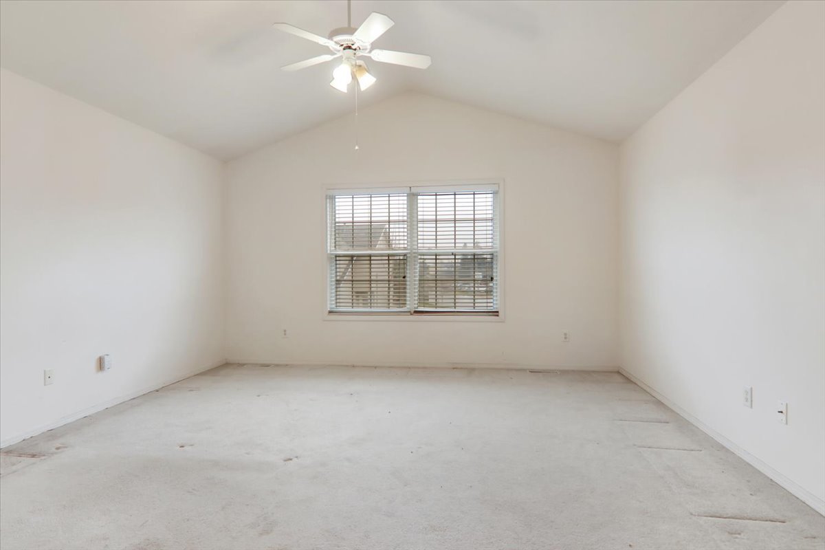 1204 Colonial Avenue Bloomington, IL 61701 - Photo 6 of 17 an empty room with a window and ceiling fan