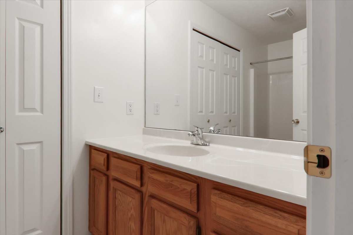 1204 Colonial Avenue Bloomington, IL 61701 - Photo 8 of 17 a bathroom with a sink and vanity