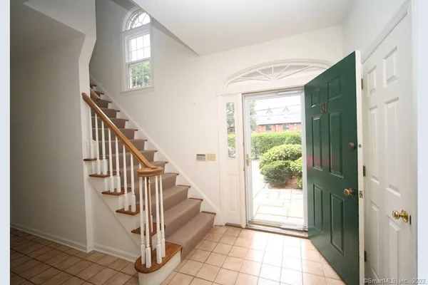 a view of entryway with wooden floor and stairs