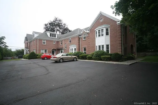 a car parked in front of a white house