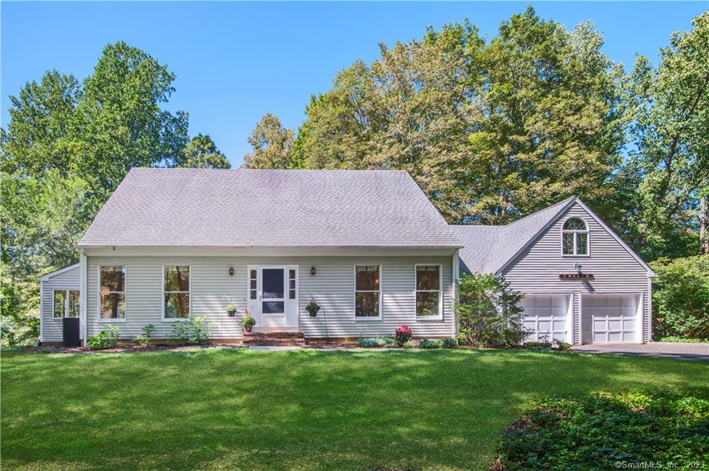 a front view of house with yard and green space