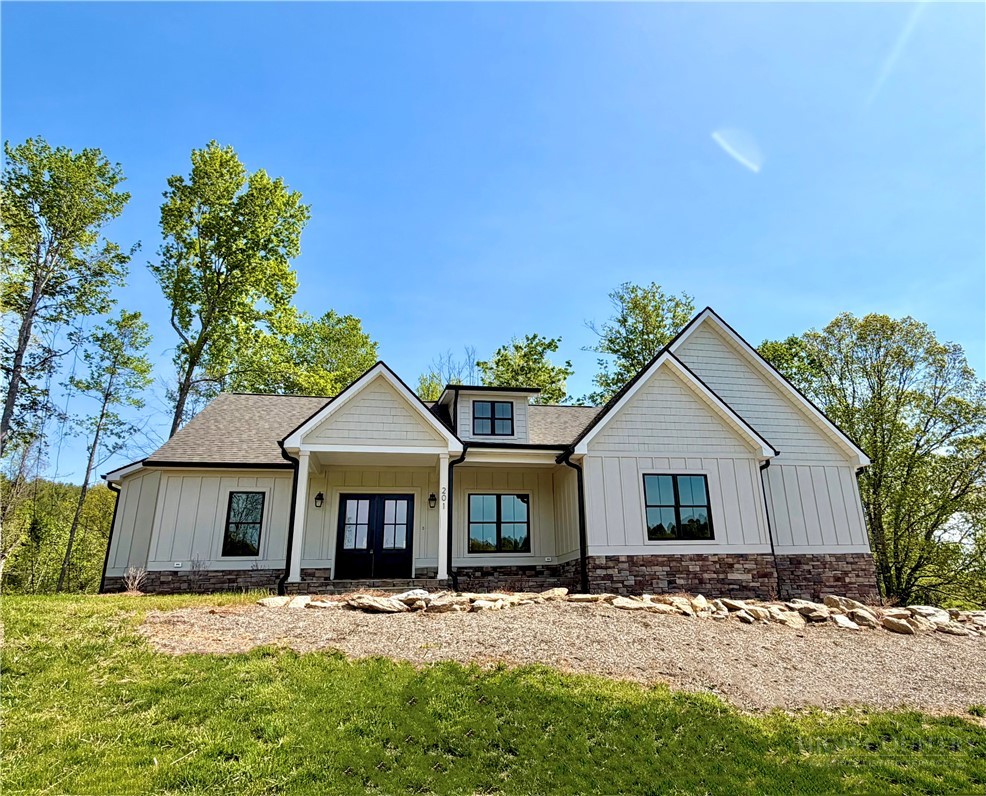 201 Whispering River Drive Crumpler, NC 28617 - Photo 1 of 48 a front view of a house with a garden and yard