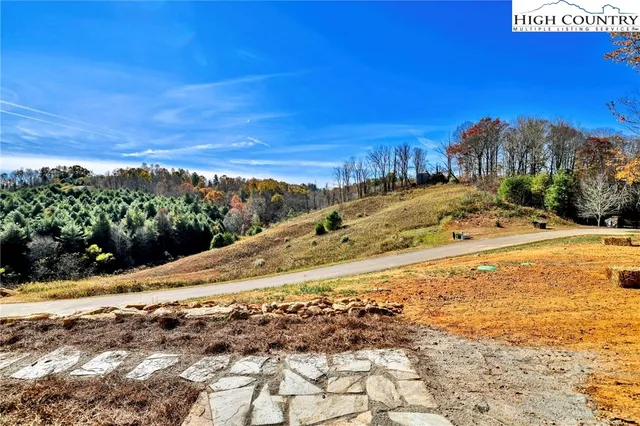 a kitchen with stainless steel appliances granite countertop a sink a stove and a wooden floors