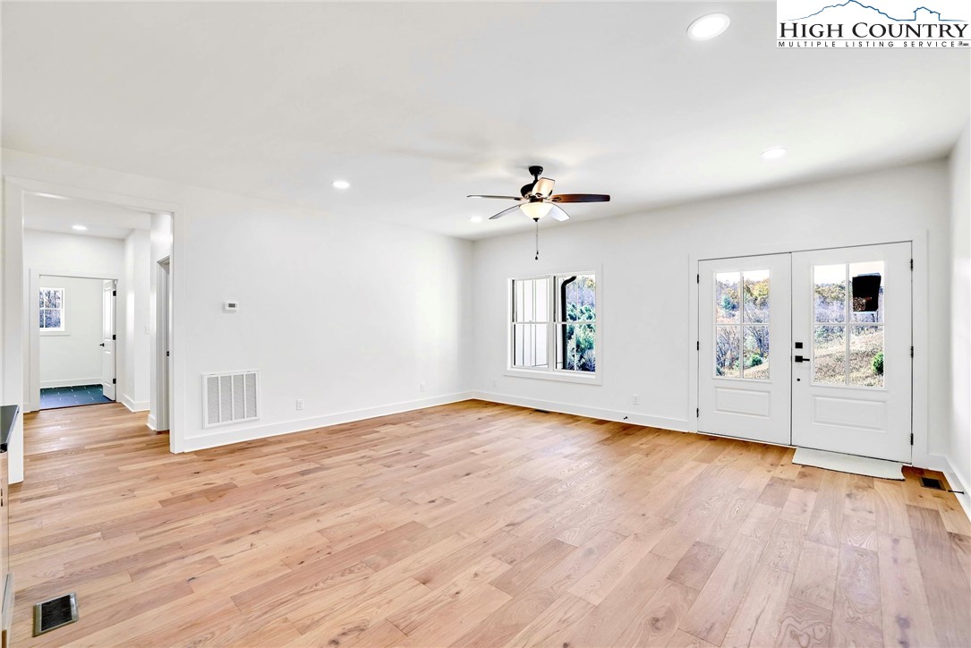 201 Whispering River Drive Crumpler, NC 28617 - Photo 12 of 48 a view of empty room with wooden floor