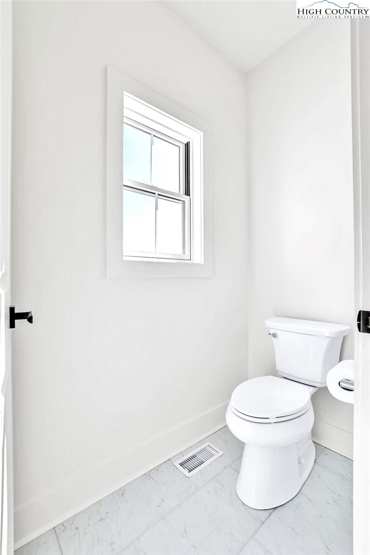 201 Whispering River Drive Crumpler, NC 28617 - Photo 29 of 48 a white toilet sitting next to a bathroom sink