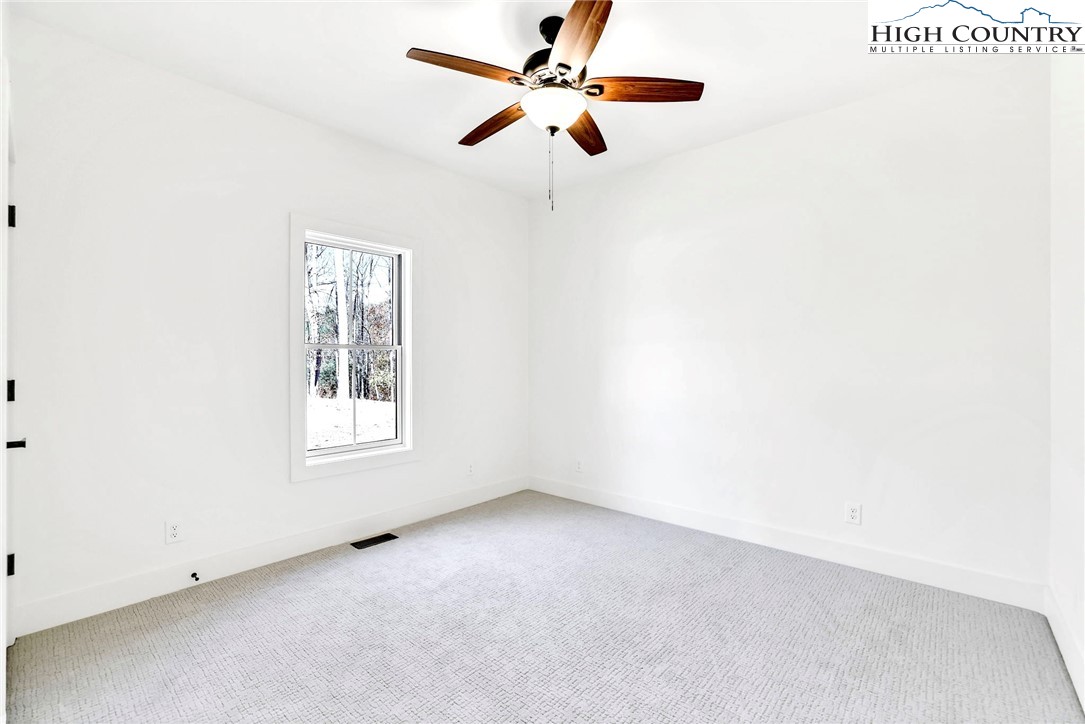201 Whispering River Drive Crumpler, NC 28617 - Photo 38 of 48 an empty room with windows and fan