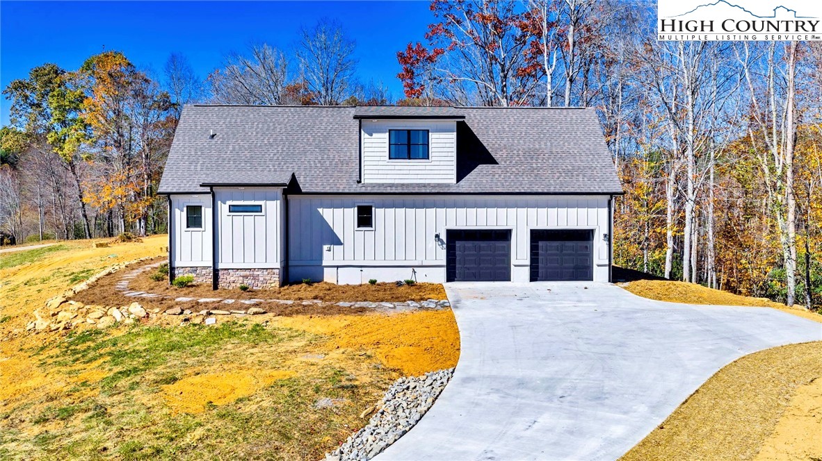 201 Whispering River Drive Crumpler, NC 28617 - Photo 7 of 48 a front view of a house with a yard