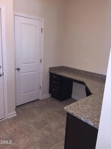 a kitchen with granite countertop a sink and a vanity