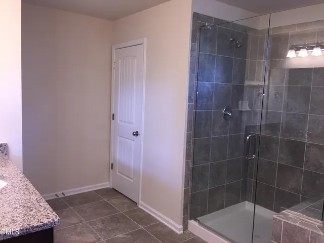 a bathroom with a granite countertop shower