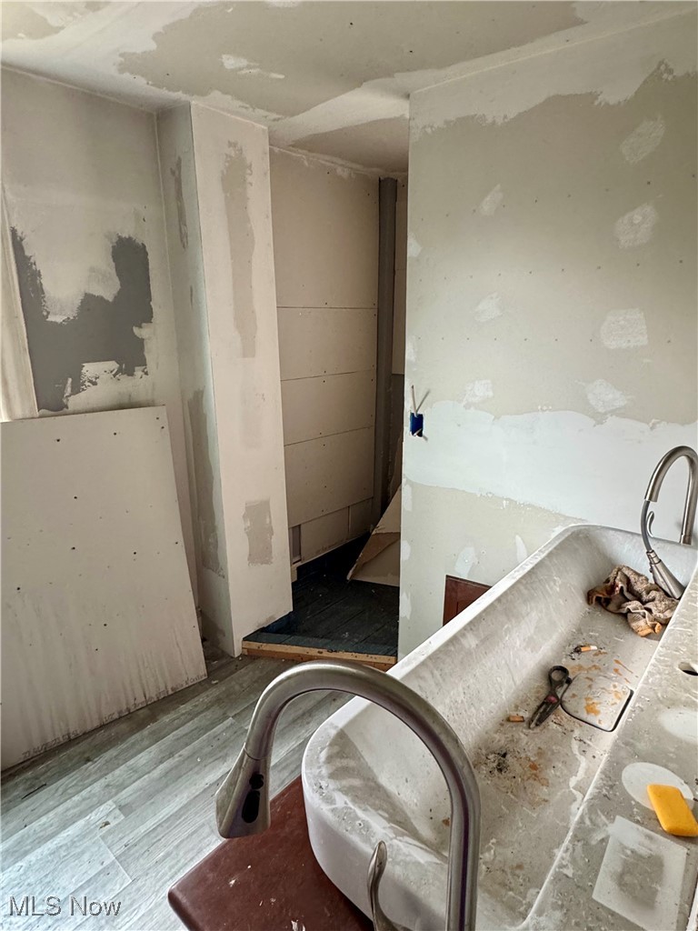6573 Williams Road Painesville, OH 44077 - Photo 16 of 32 Bathroom with hardwood / wood-style floors